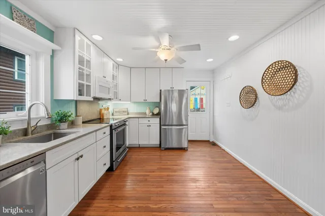 a kitchen with refrigerator cabinets and a sink