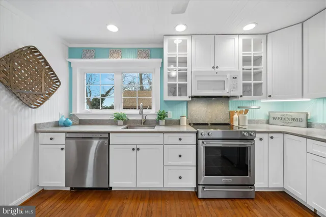 a kitchen with stainless steel appliances granite countertop a stove and a sink