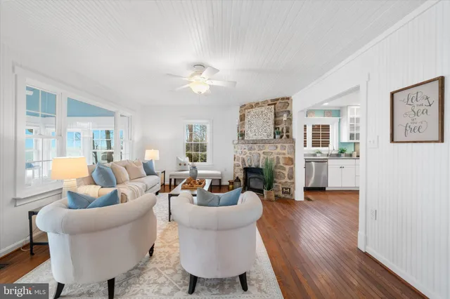 a living room with fireplace furniture and a wooden floor