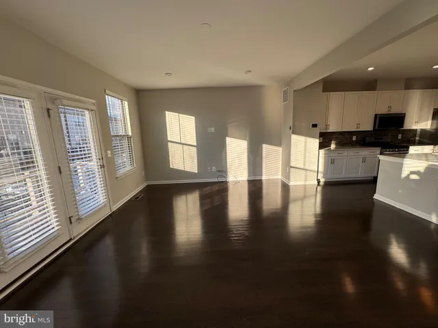 a view of a kitchen with a stove top oven a sink a dishwasher with wooden floor and cabinets