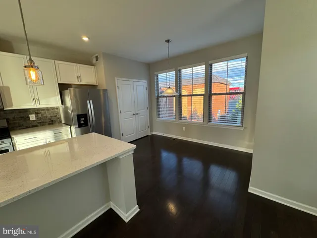 a kitchen with stainless steel appliances a refrigerator and a stove top oven