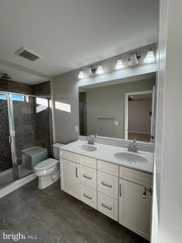 a bathroom with a double vanity sink and a mirror
