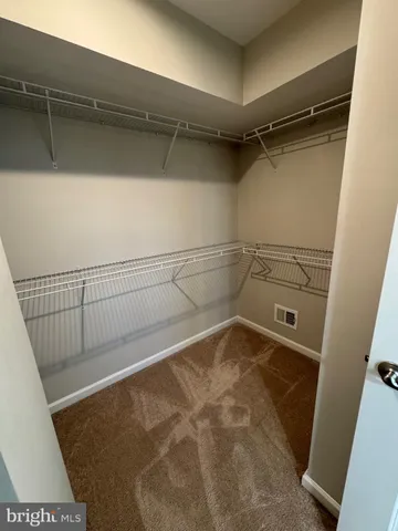 an empty room with closet and windows
