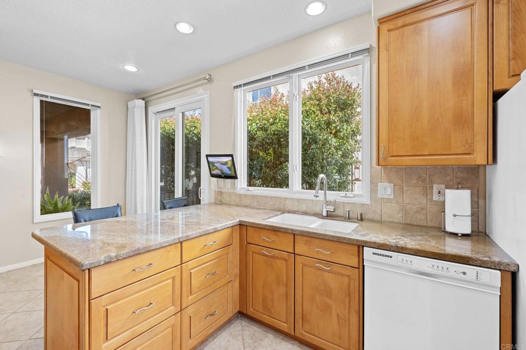 1827 Amalfi Drive Encinitas, CA 92024 - Photo 13 of 31 a kitchen with granite countertop sink and large window