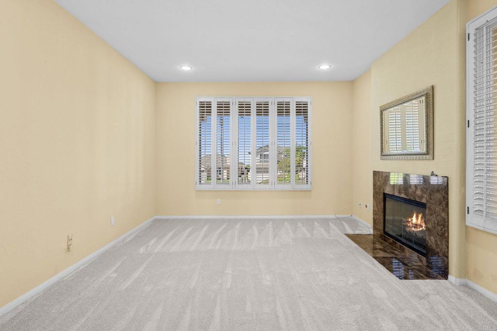 1827 Amalfi Drive Encinitas, CA 92024 - Photo 16 of 31 a view of an empty room with window and fire place