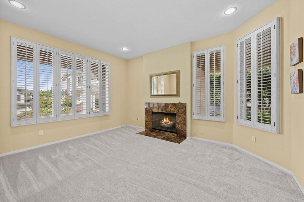 1827 Amalfi Drive Encinitas, CA 92024 - Photo 17 of 31 a view of an empty room with a fireplace and a window
