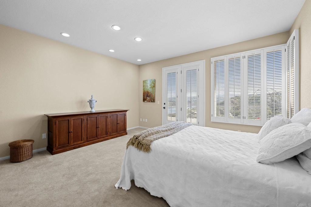 1827 Amalfi Drive Encinitas, CA 92024 - Photo 21 of 31 a bedroom with a bed and window