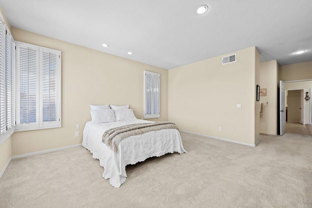 1827 Amalfi Drive Encinitas, CA 92024 - Photo 22 of 31 a spacious bedroom with a bed and a large window