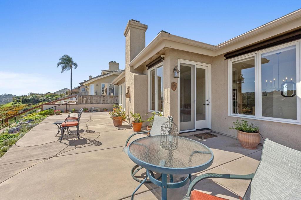 1827 Amalfi Drive Encinitas, CA 92024 - Photo 27 of 31 a view of a patio with couches table and chairs potted plants