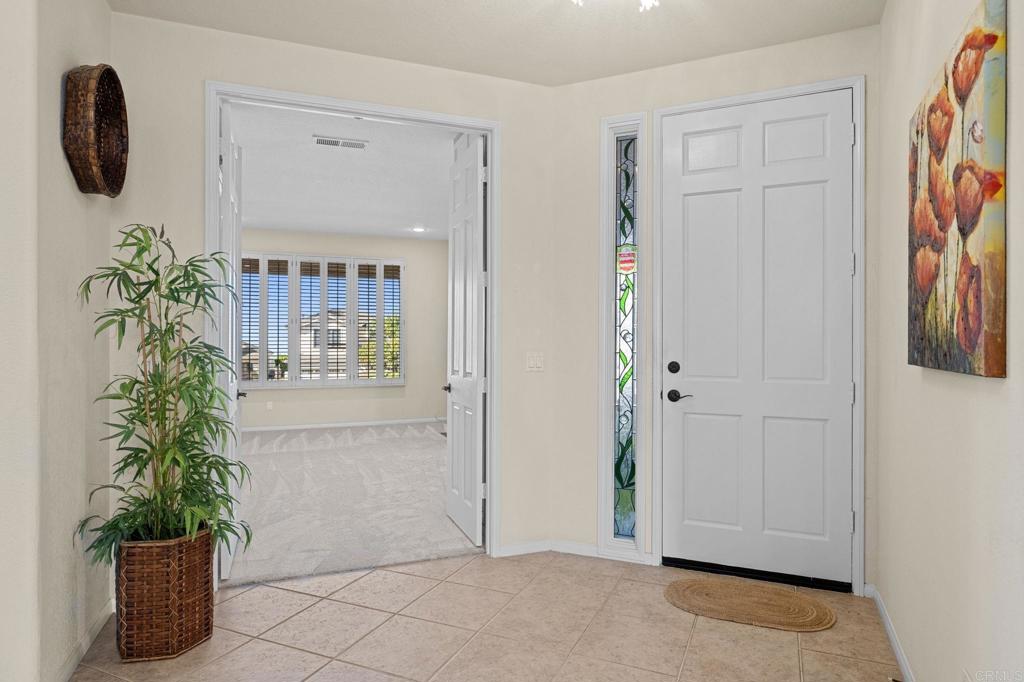 1827 Amalfi Drive Encinitas, CA 92024 - Photo 6 of 31 an entryway with wooden floor and a potted plant