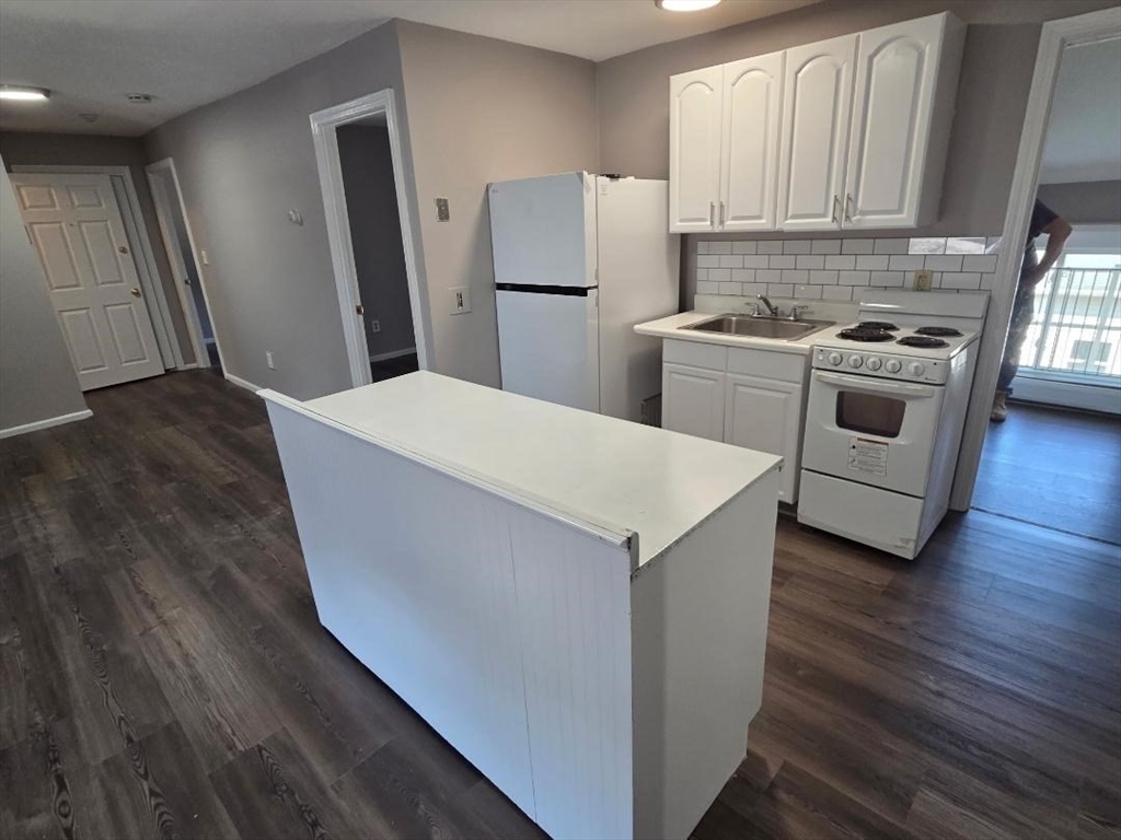 14 Carver Street, Unit 3 Fall River, MA 02721 - Photo 1 of 8 a kitchen with a stove a refrigerator and a sink