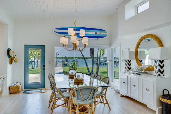 a view of a dining room with furniture a chandelier and wooden floor