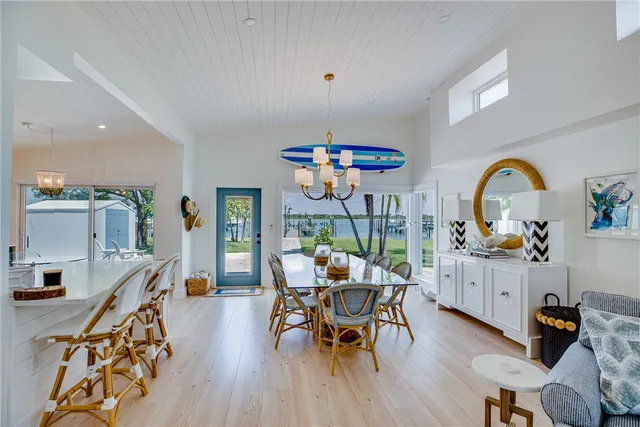 a dining room with furniture a chandelier and wooden floor