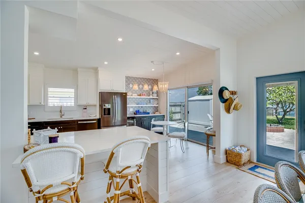 a living room with dining table furniture and windows