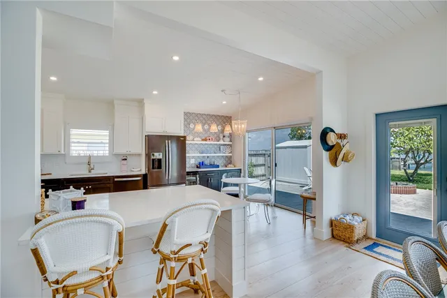 a living room with dining table furniture and windows