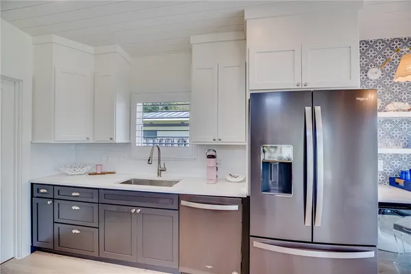 a kitchen with stainless steel appliances granite countertop a refrigerator sink and cabinets