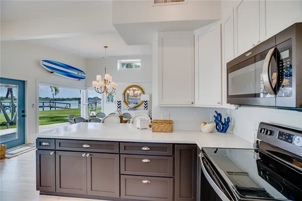 a kitchen with a sink a stove and cabinets