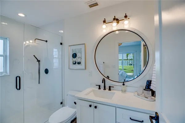 a bedroom with two beds and wooden floor