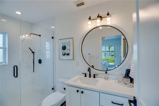 a bedroom with two beds and wooden floor