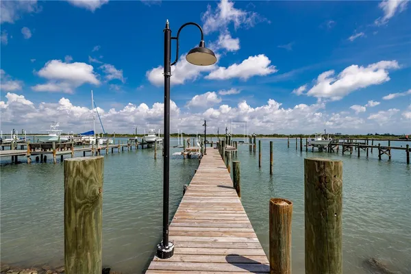 an aerial view of house with yard and ocean view