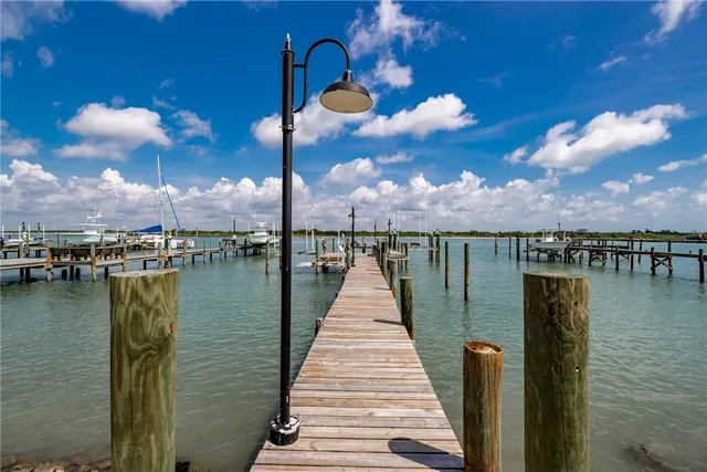 an aerial view of house with yard and ocean view