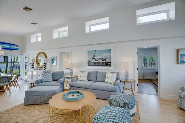 a living room with furniture a rug and a table