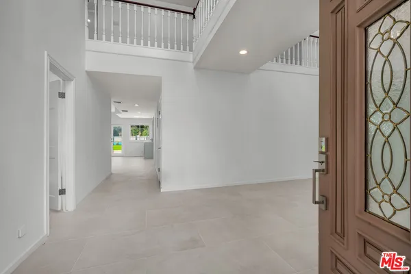 a view of an entryway with wooden floor