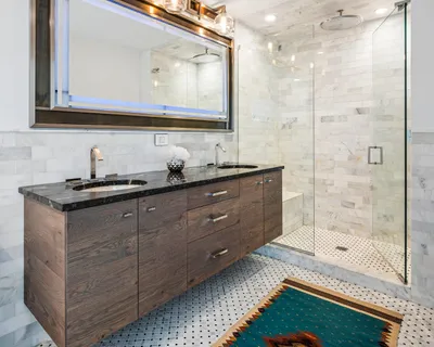 a bathroom with a sink a mirror and a shower
