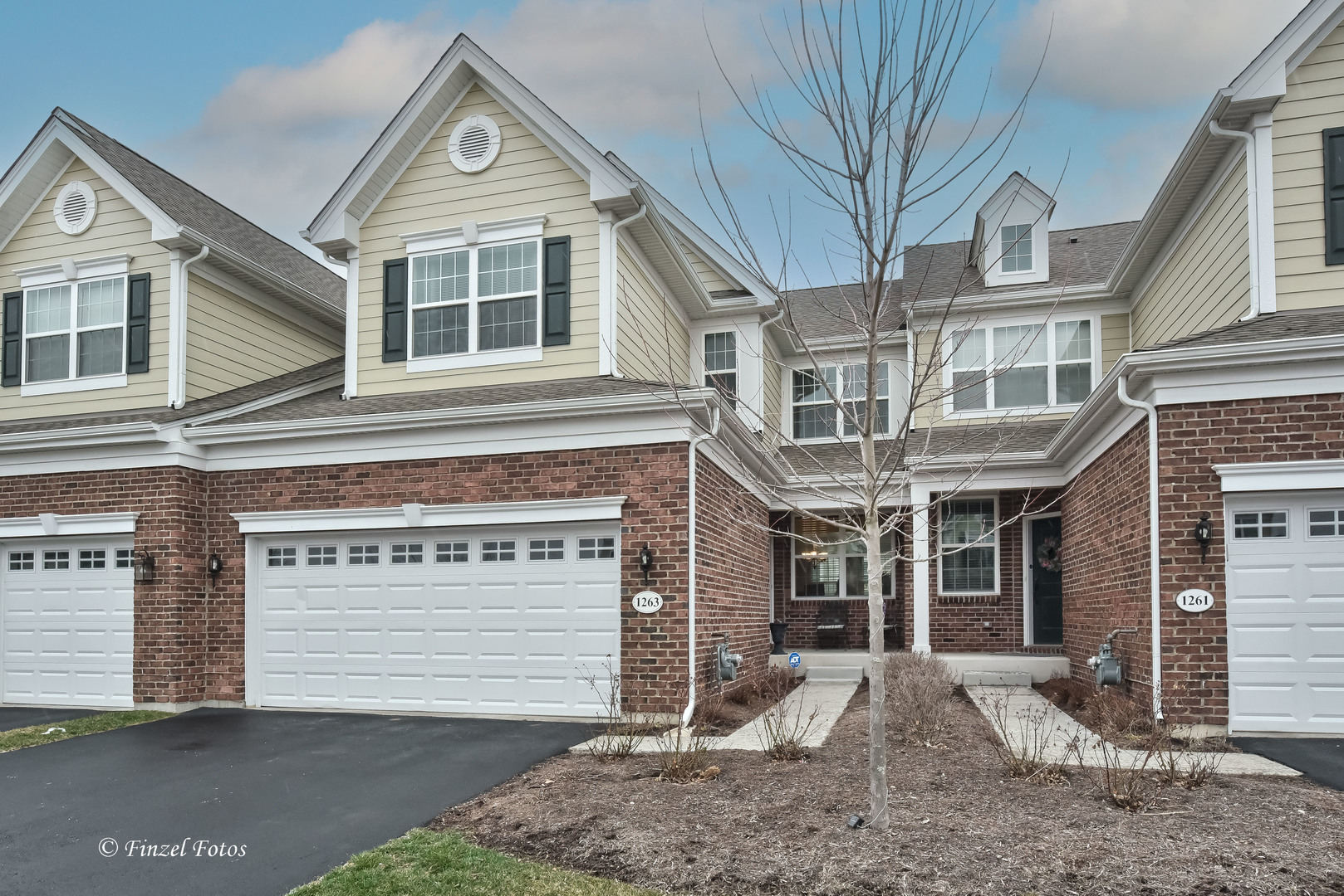 1263 Falcon Ridge Drive Elgin, IL 60124 - Photo 1 of 1 a front view of a house with a yard and garage