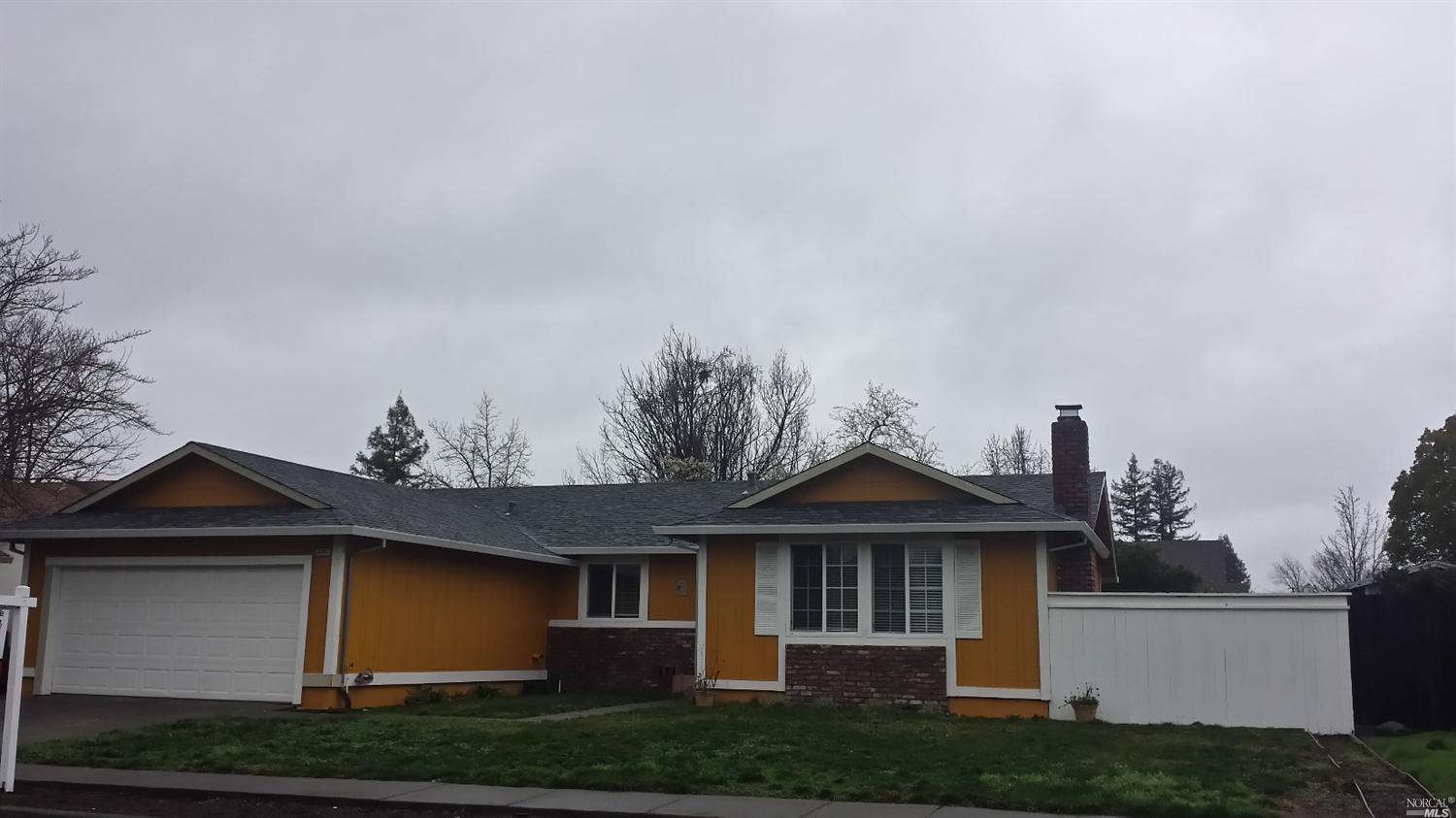 2311 Floral Way Santa Rosa, CA 95403 - Photo 1 of 1 a front view of a house with a yard and garage
