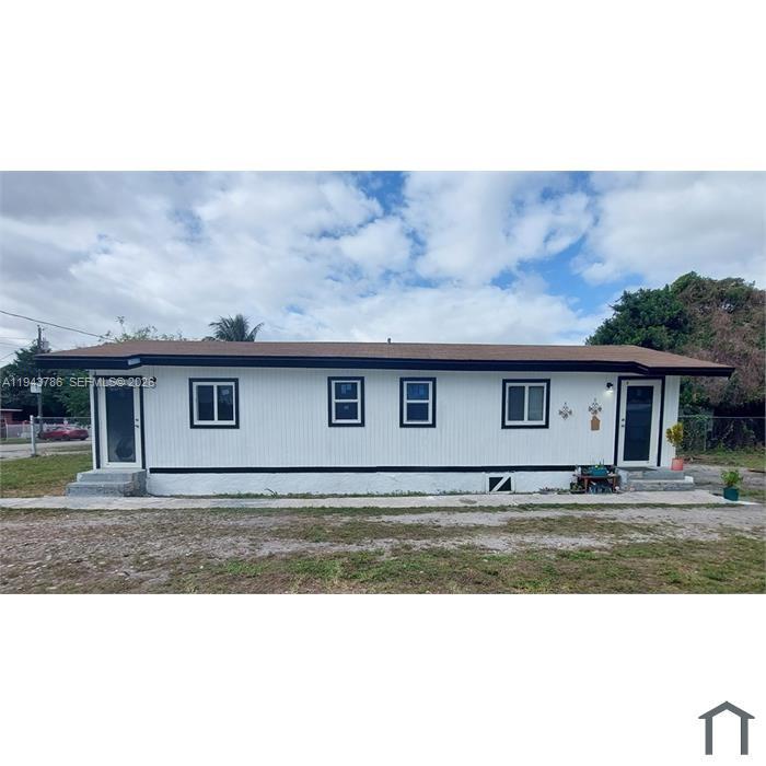 2927 Northwest 60th Street Miami, FL 33142 - Photo 2 of 11 a view of a house with a big yard