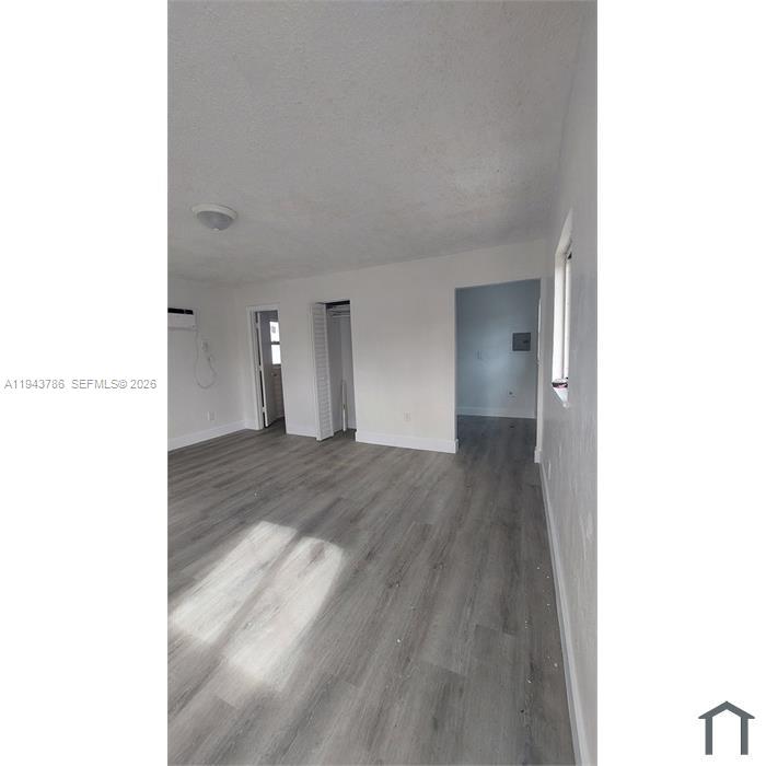 2927 Northwest 60th Street Miami, FL 33142 - Photo 5 of 11 a view of an empty room with wooden floor