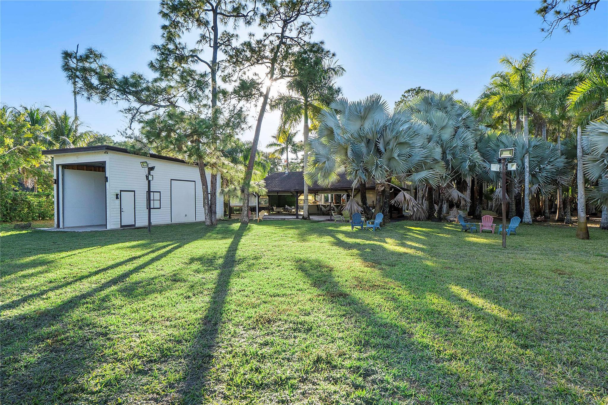5351 Godfrey Road Parkland, FL 33067 - Photo 80 of 95 a backyard of a house with plants and large tree