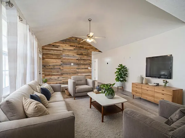 a living room with furniture and a flat screen tv