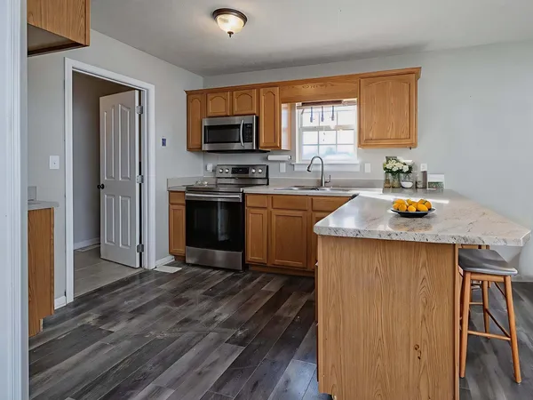 a kitchen with a sink a stove and a microwave