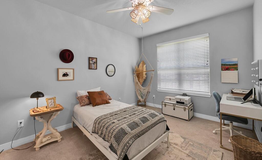 550 Hunton Lane Robinson, TX 76706 - Photo 22 of 35 Bedroom with light colored carpet, an office area, multiple windows, and a ceiling fan