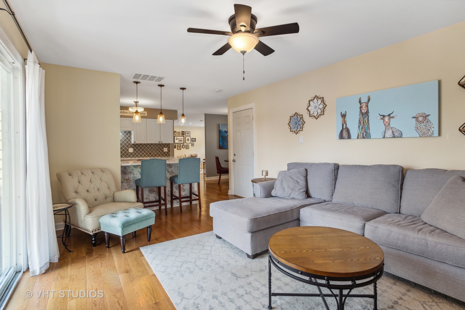 7 Windsor Court Streamwood, IL 60107 - Photo 11 of 22 a living room with furniture and a chandelier