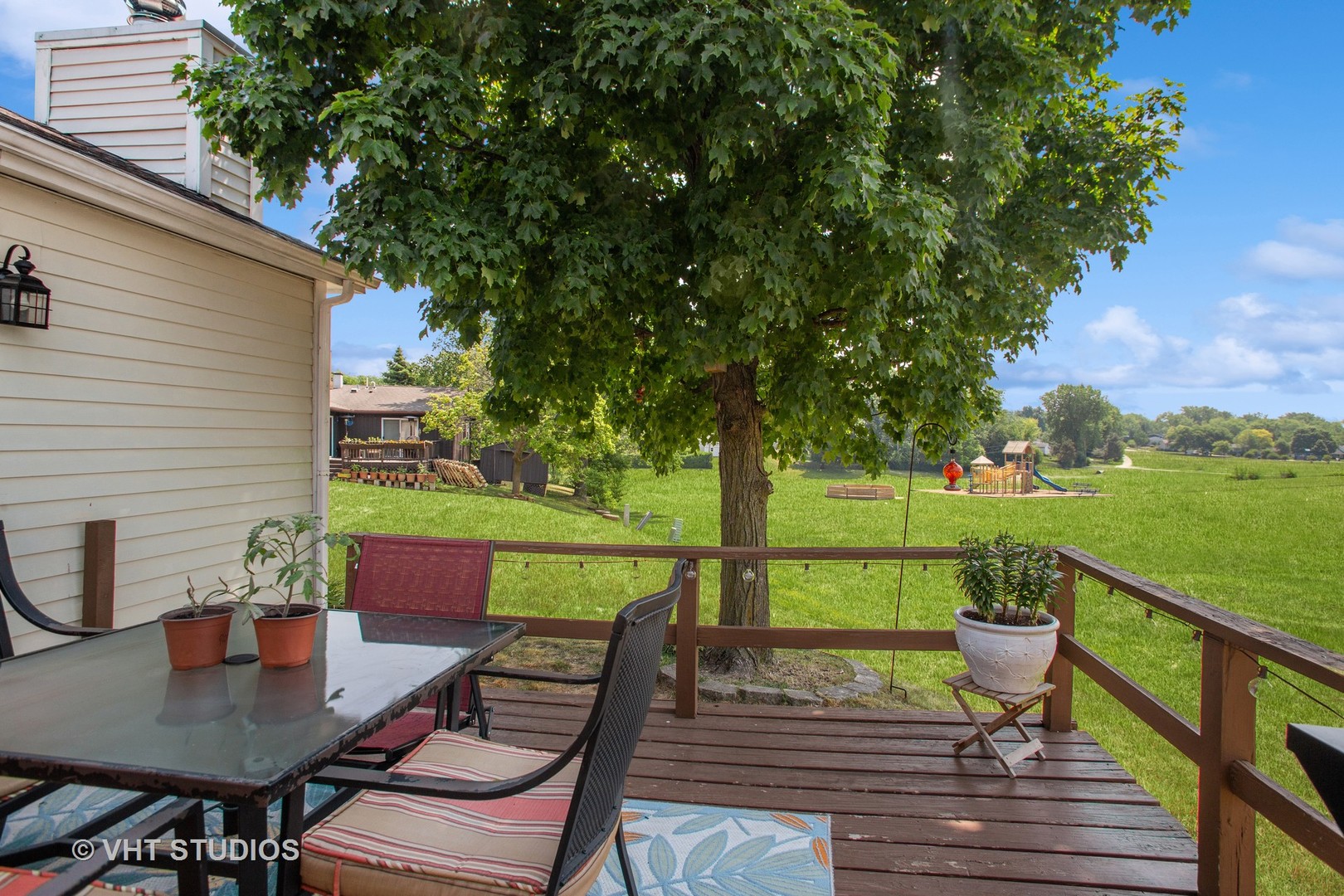 7 Windsor Court Streamwood, IL 60107 - Photo 20 of 22 a view of a deck with couches table and chairs under an umbrella