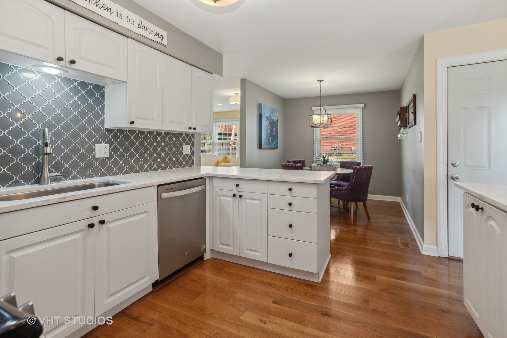 7 Windsor Court Streamwood, IL 60107 - Photo 7 of 22 a kitchen with a sink window and cabinets