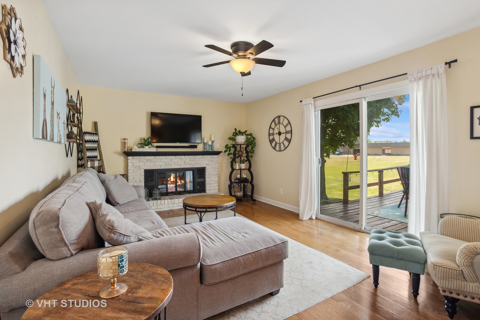 7 Windsor Court Streamwood, IL 60107 - Photo 10 of 22 a living room with furniture a flat screen tv and a fireplace