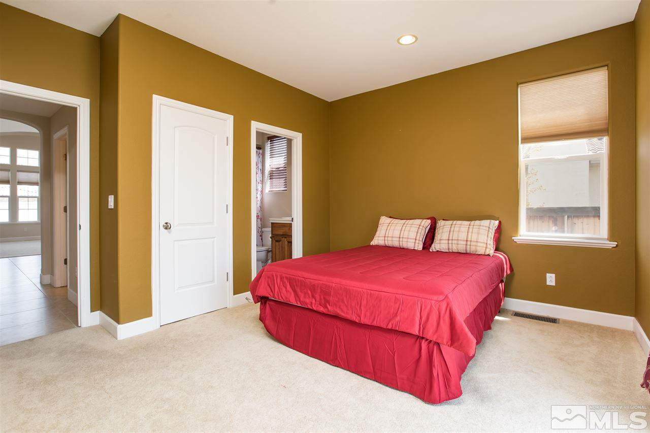 8548 Timaru Trail Reno, NV 89523 - Photo 14 of 25 a bedroom with a bed and wooden floor