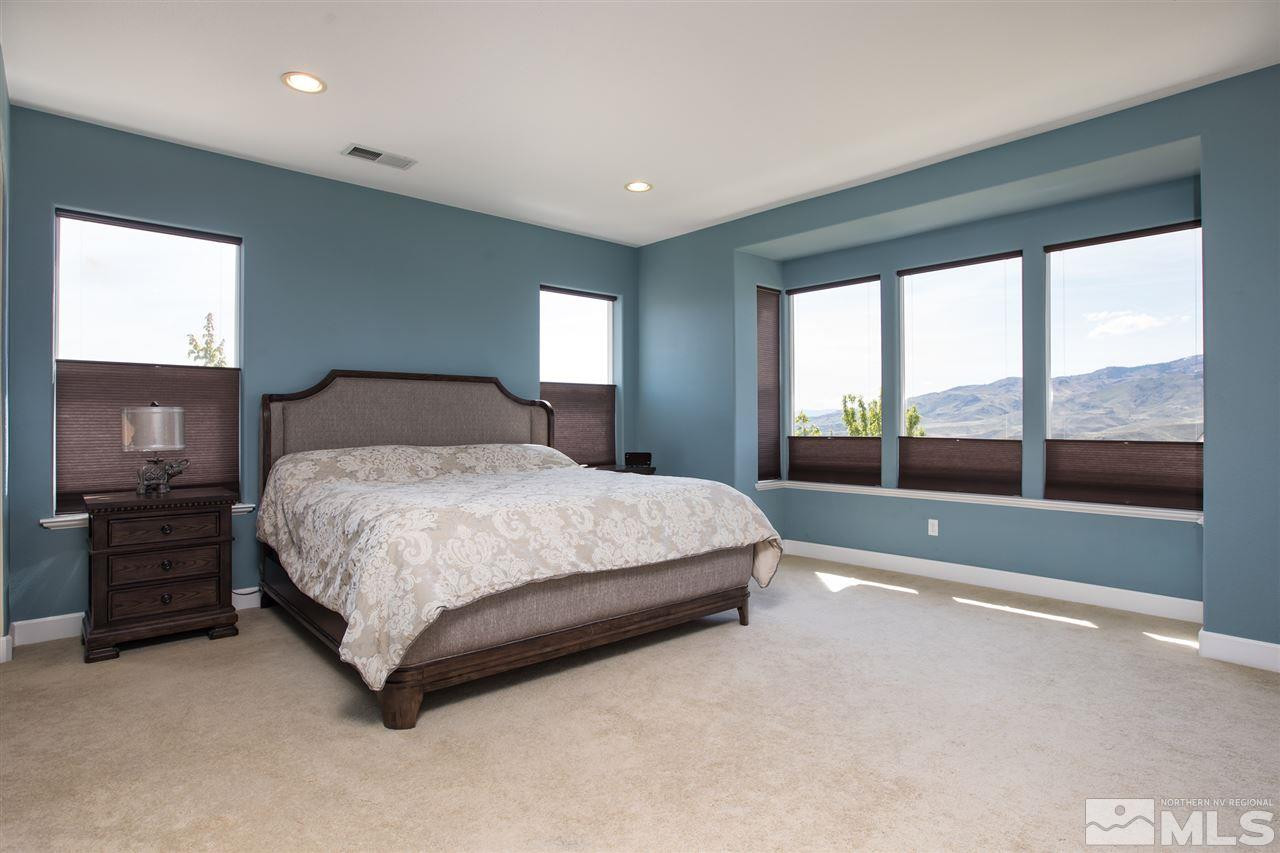 8548 Timaru Trail Reno, NV 89523 - Photo 15 of 25 a spacious bedroom with a large bed and a balcony view