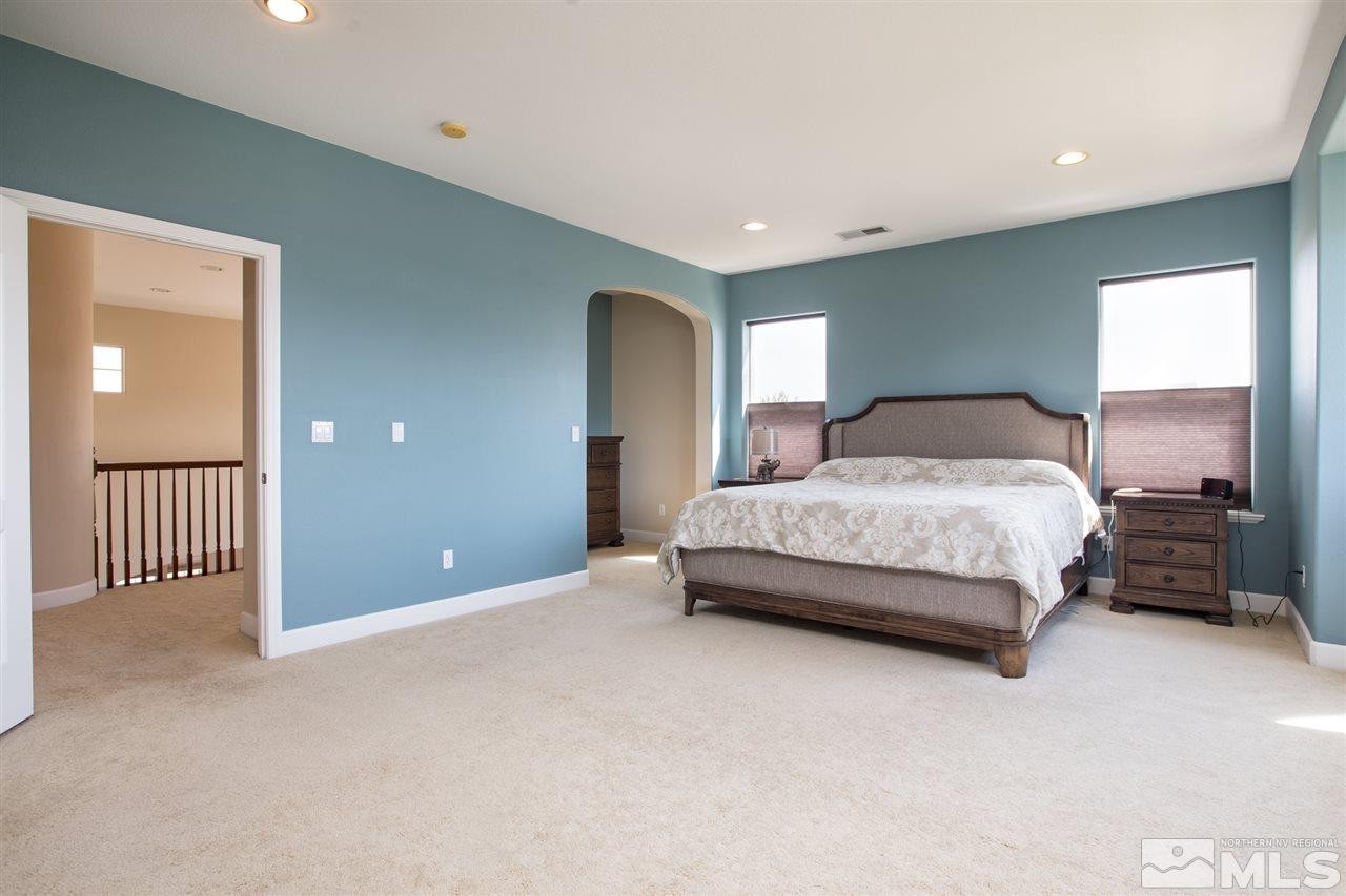 8548 Timaru Trail Reno, NV 89523 - Photo 16 of 25 a bedroom with a bed and a lamp