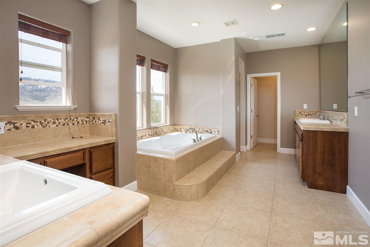 8548 Timaru Trail Reno, NV 89523 - Photo 17 of 25 a spacious bathroom with a tub sink and mirror