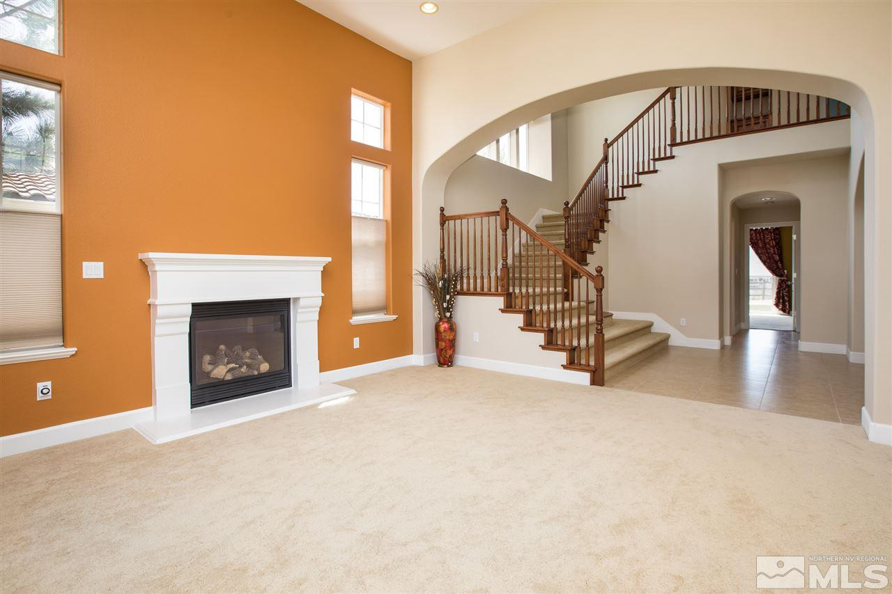 8548 Timaru Trail Reno, NV 89523 - Photo 5 of 25 a view of a livingroom with wooden floor and a fireplace