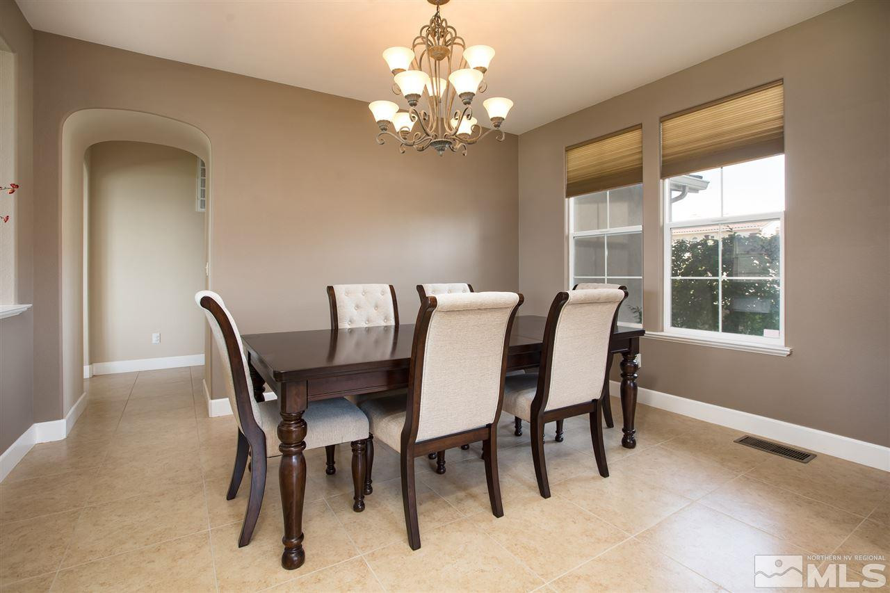 8548 Timaru Trail Reno, NV 89523 - Photo 7 of 25 a view of a dining room with furniture and chandelier