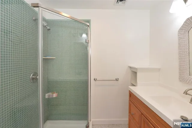 a bathroom with a sink and shower