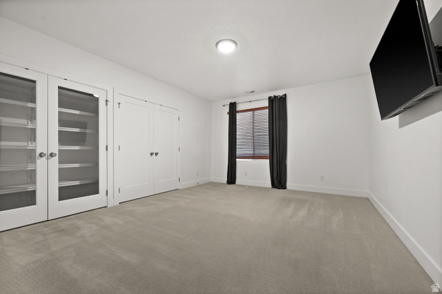 507 West Windmill Gate Cove Draper, UT 84020 - Photo 39 of 46 Unfurnished bedroom with light carpet and multiple closets