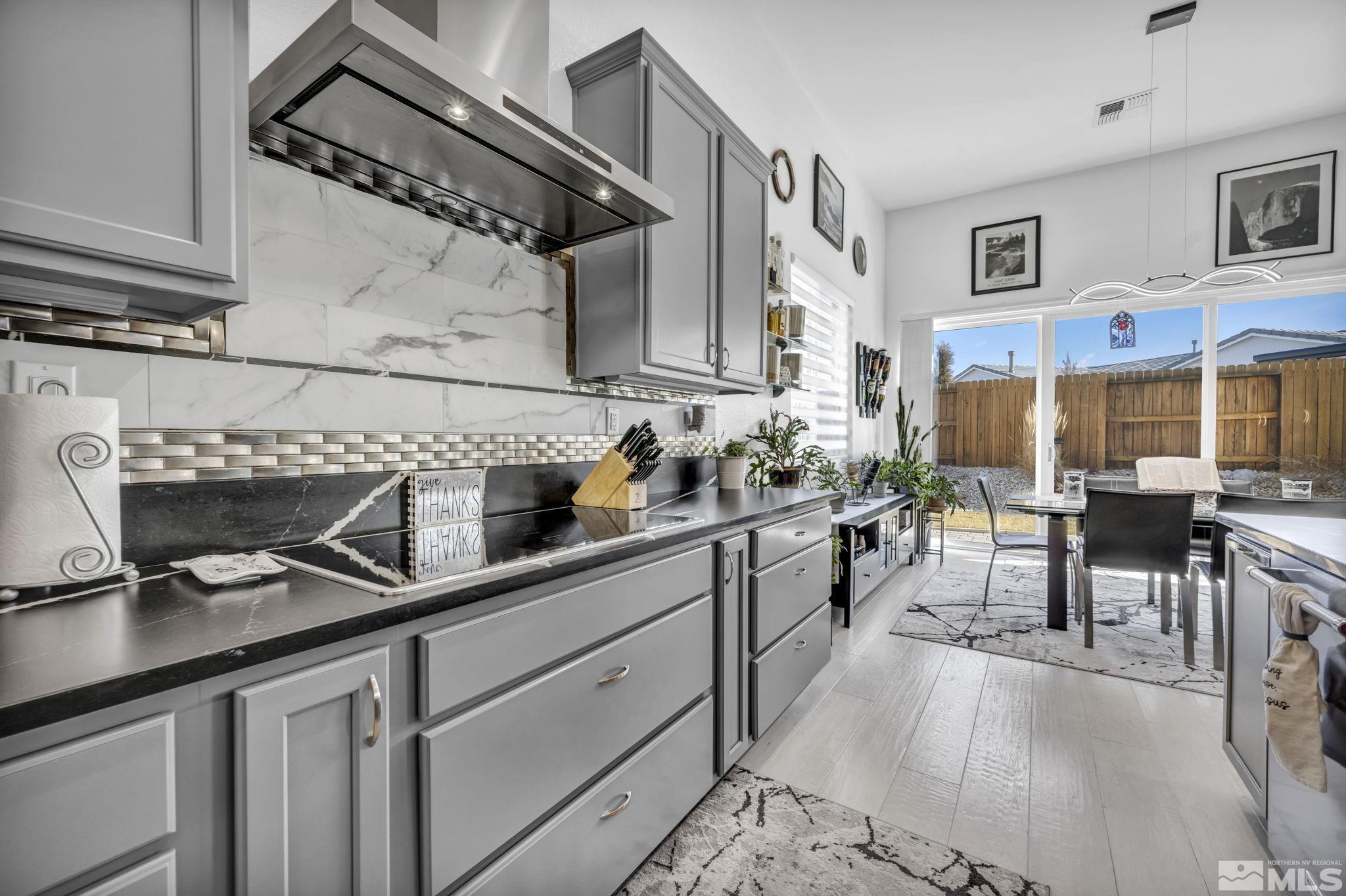 9500 Hawkshead Road Reno, NV 89521 - Photo 15 of 40 a kitchen with stainless steel appliances granite countertop a sink a stove and cabinets