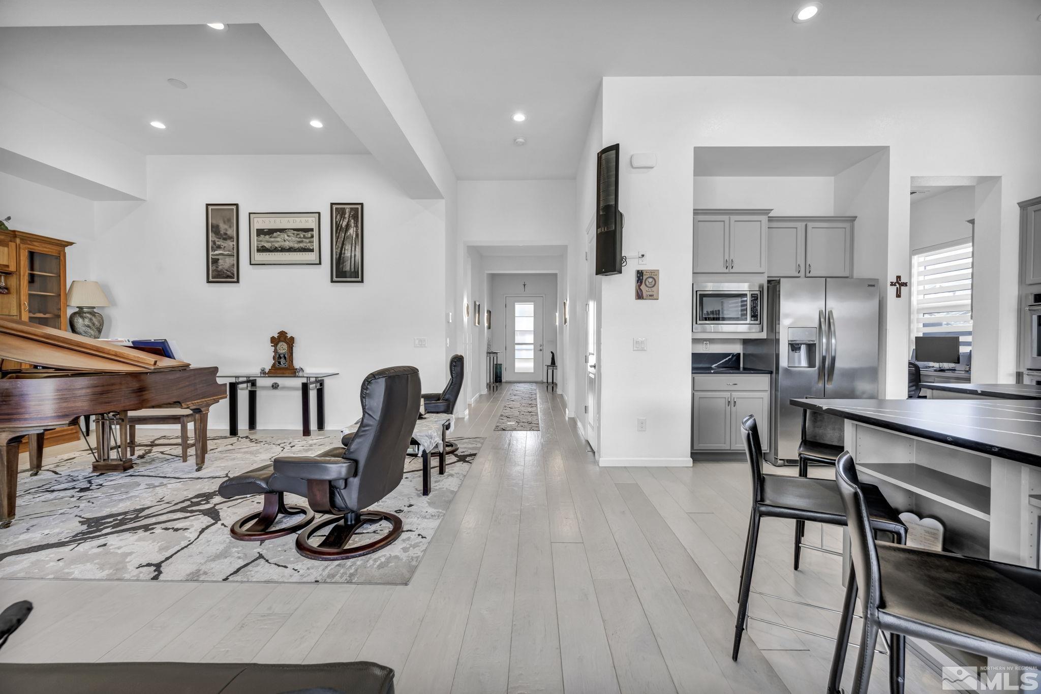 9500 Hawkshead Road Reno, NV 89521 - Photo 19 of 40 a living room with stainless steel appliances kitchen island granite countertop furniture and a wooden floor